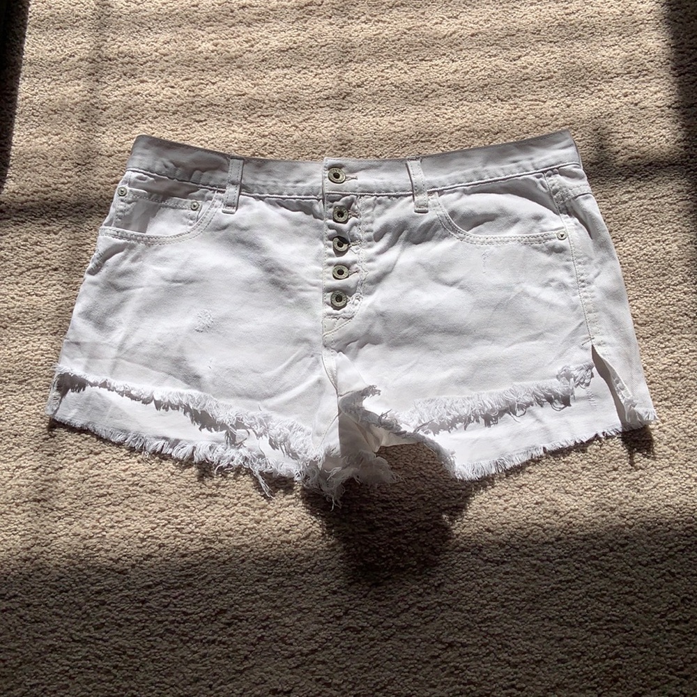 Free People distressed white denim shorts. Size 29.